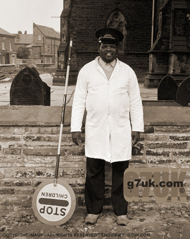 School crossing attendant takes a break in front of St.John's church, Longsight, probably 1985