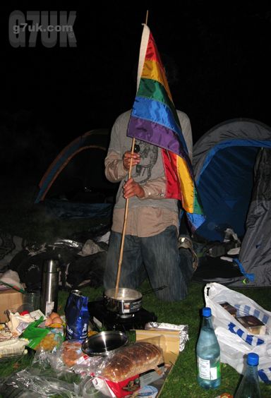 Stirring the food with a freedom flag at Queeruption 2010 base camp. Someone forgot the cooking utensils!