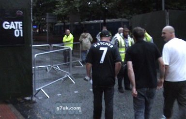 The three approach the gate at Sackville Street. Apparently taking out tickets to be let into Manchester Pride.