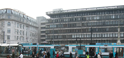 Early morning commuters leave a tram in St. Peters Square, Manchester in April 2008