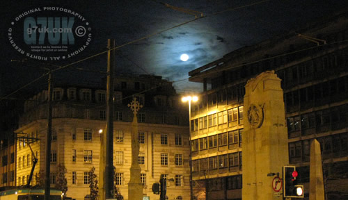 St. Peters Square, Manchester, at night with a full moon and tram. 31st Dec 2009.